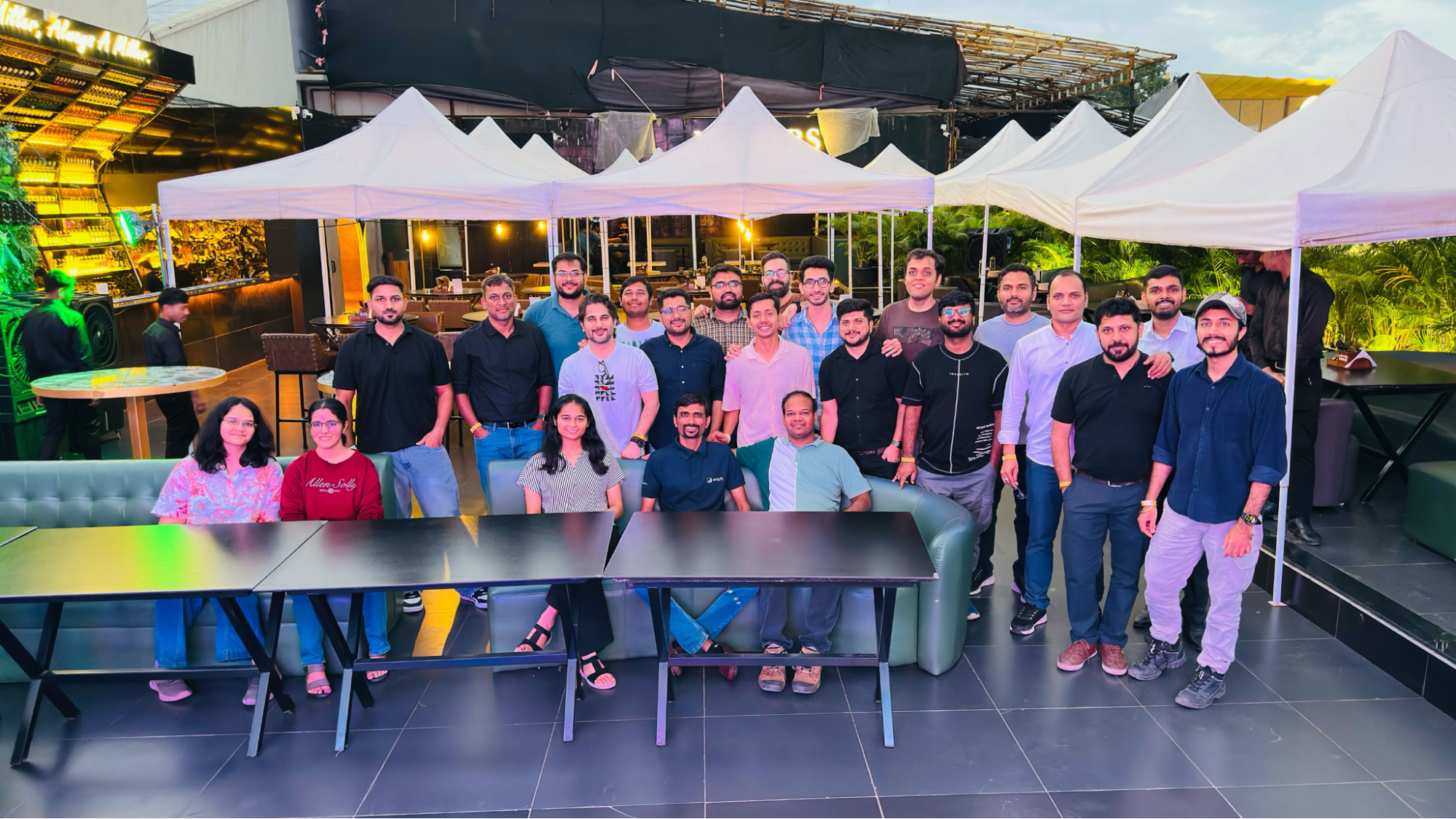 Team gathering at restaurant table for a picture